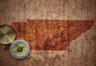 Map of tennessee state on a old vintage crack paper background with compass