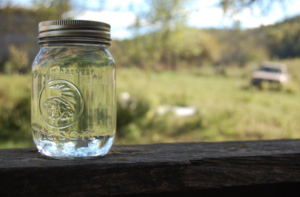 Clear mason jar of moonshine.