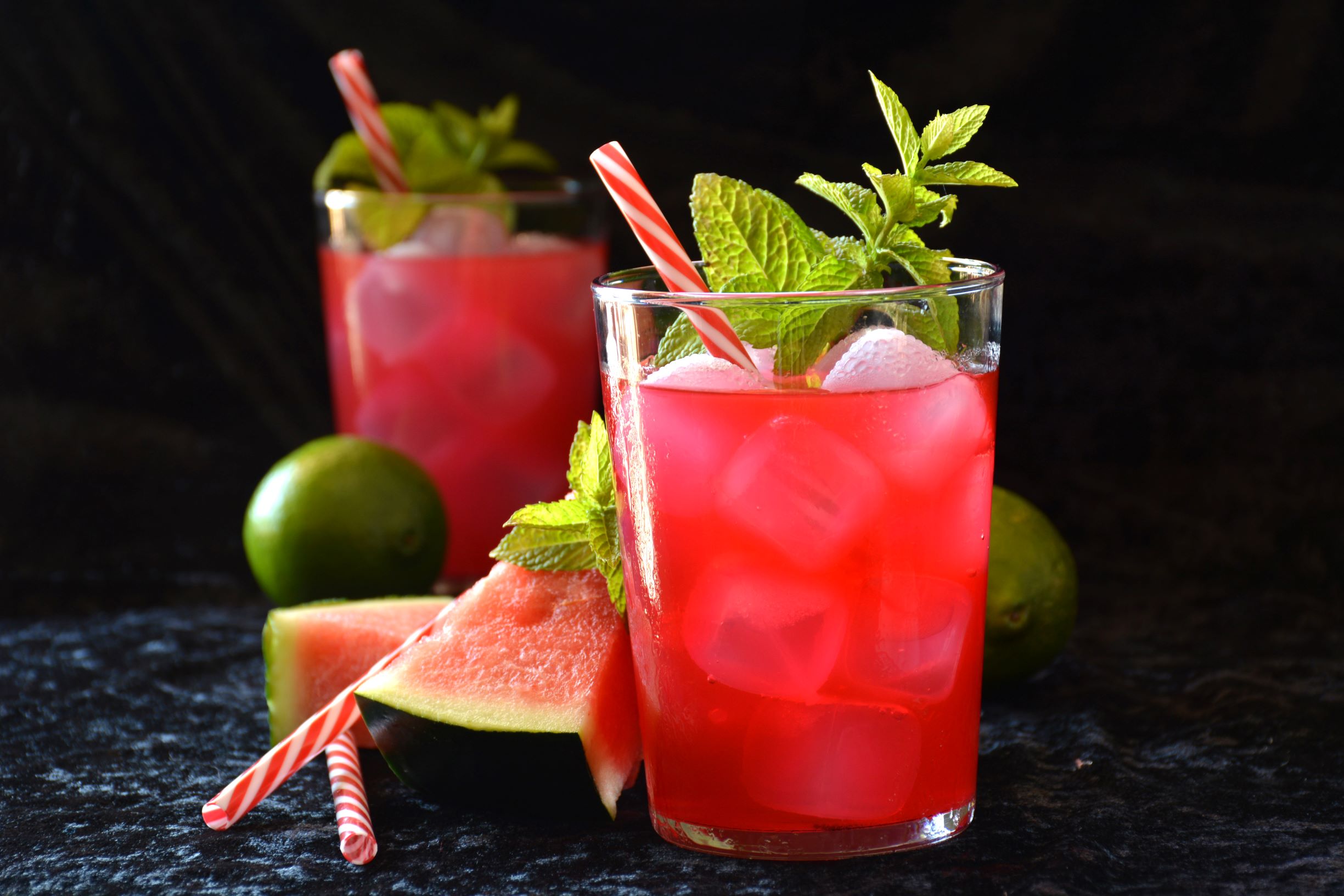 Two summer time watermelon mojitos with lime and mint