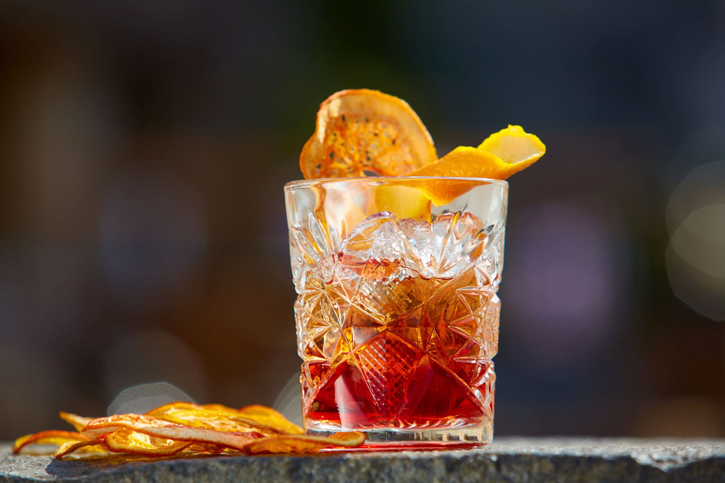 Old fashioned whiskey with an orange peel.