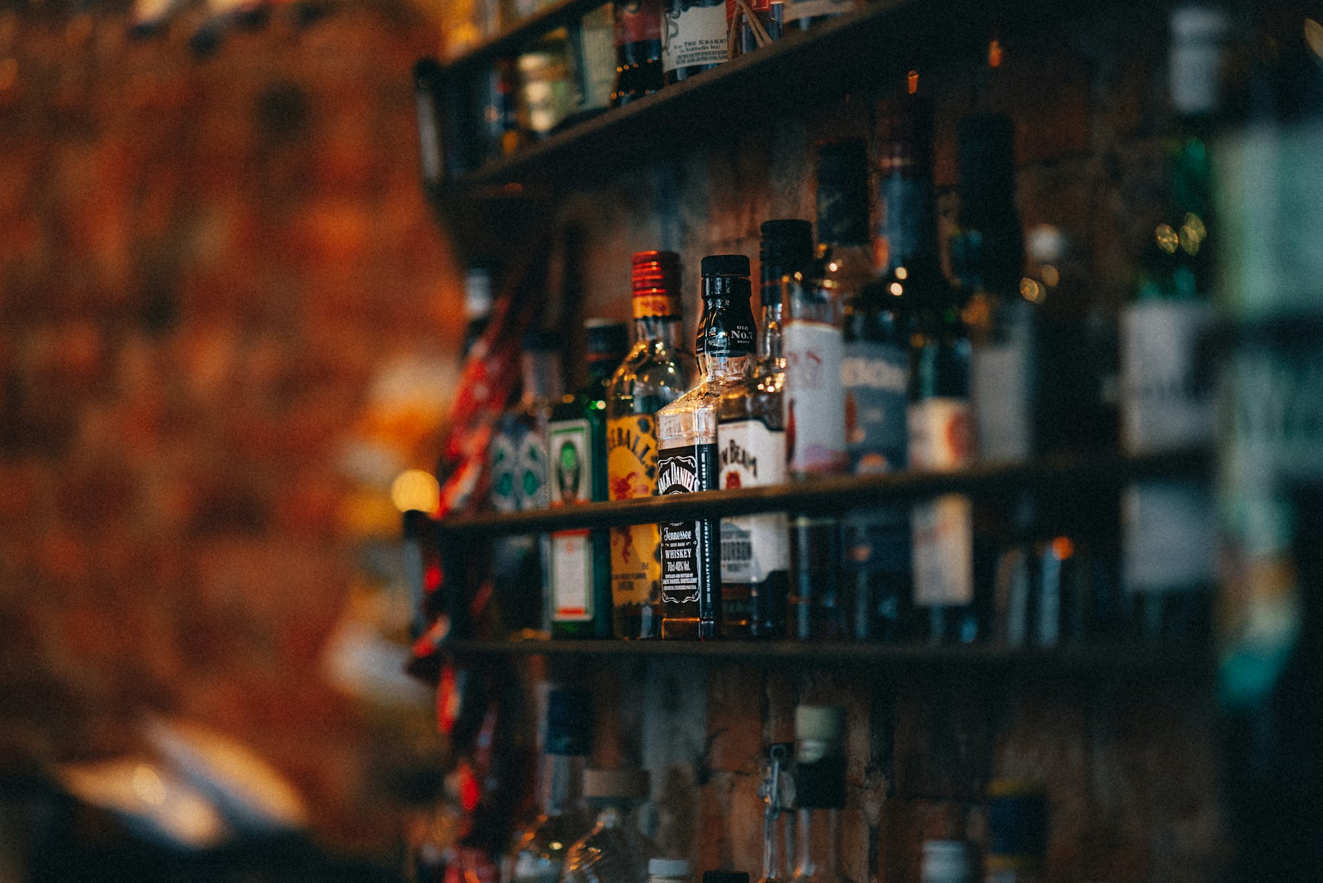 Bottles of spirits on a wooden shelf